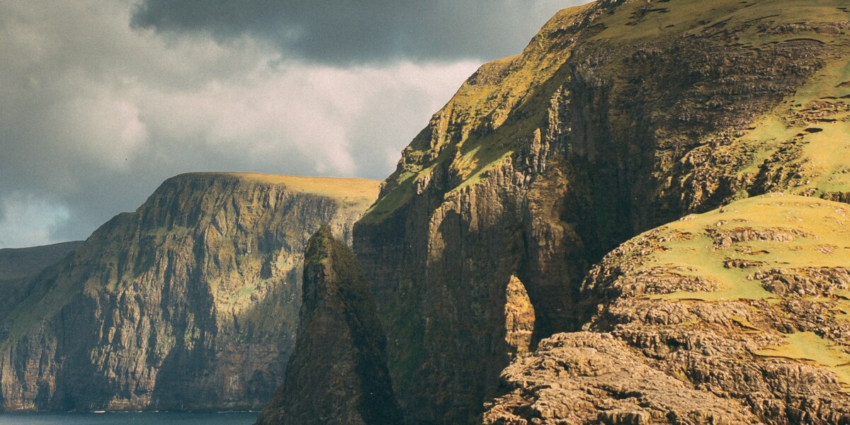 Dramatic rocky coastline of Fair Isle with golden cliffs